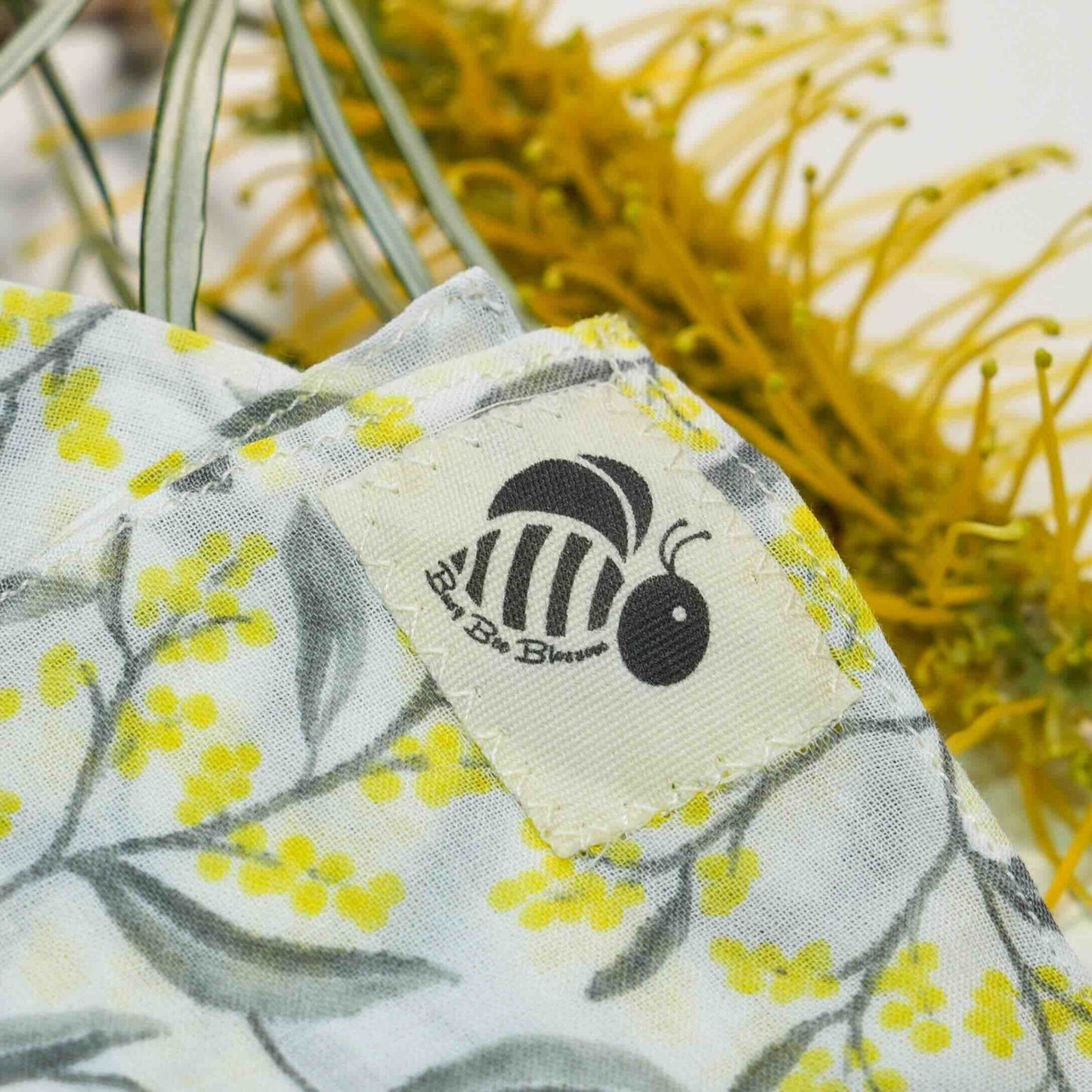Close-up of Organic Muslin facecloth in wattle print