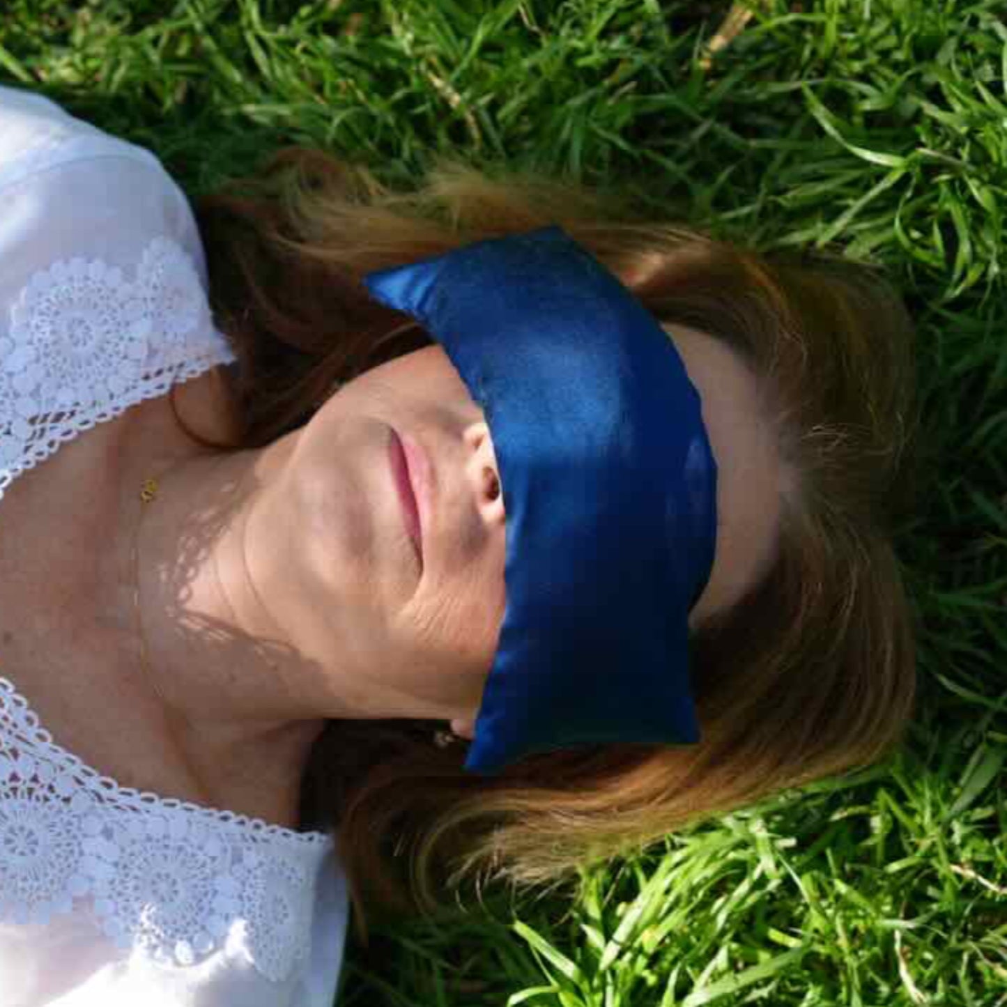Louise with deep blue silk eye pillow covering eyes