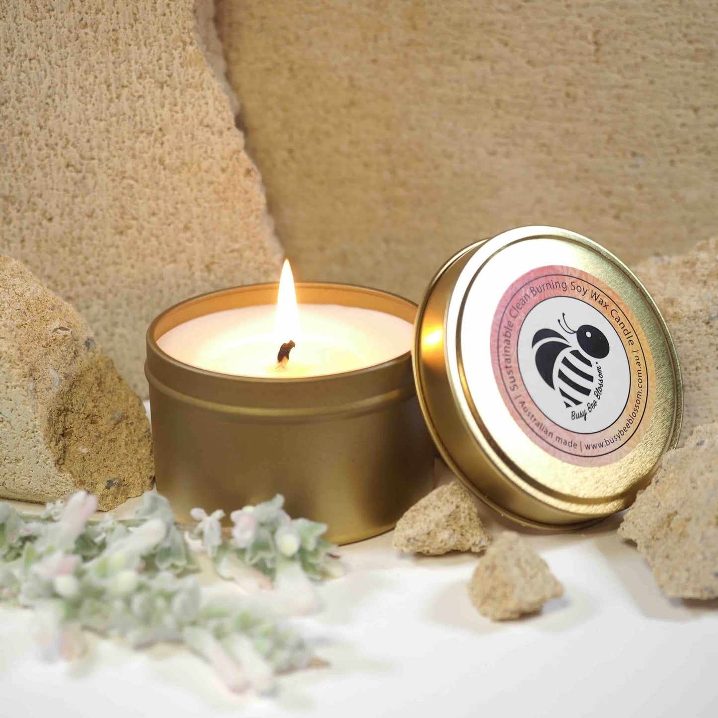 Gold travel tin candle burning
