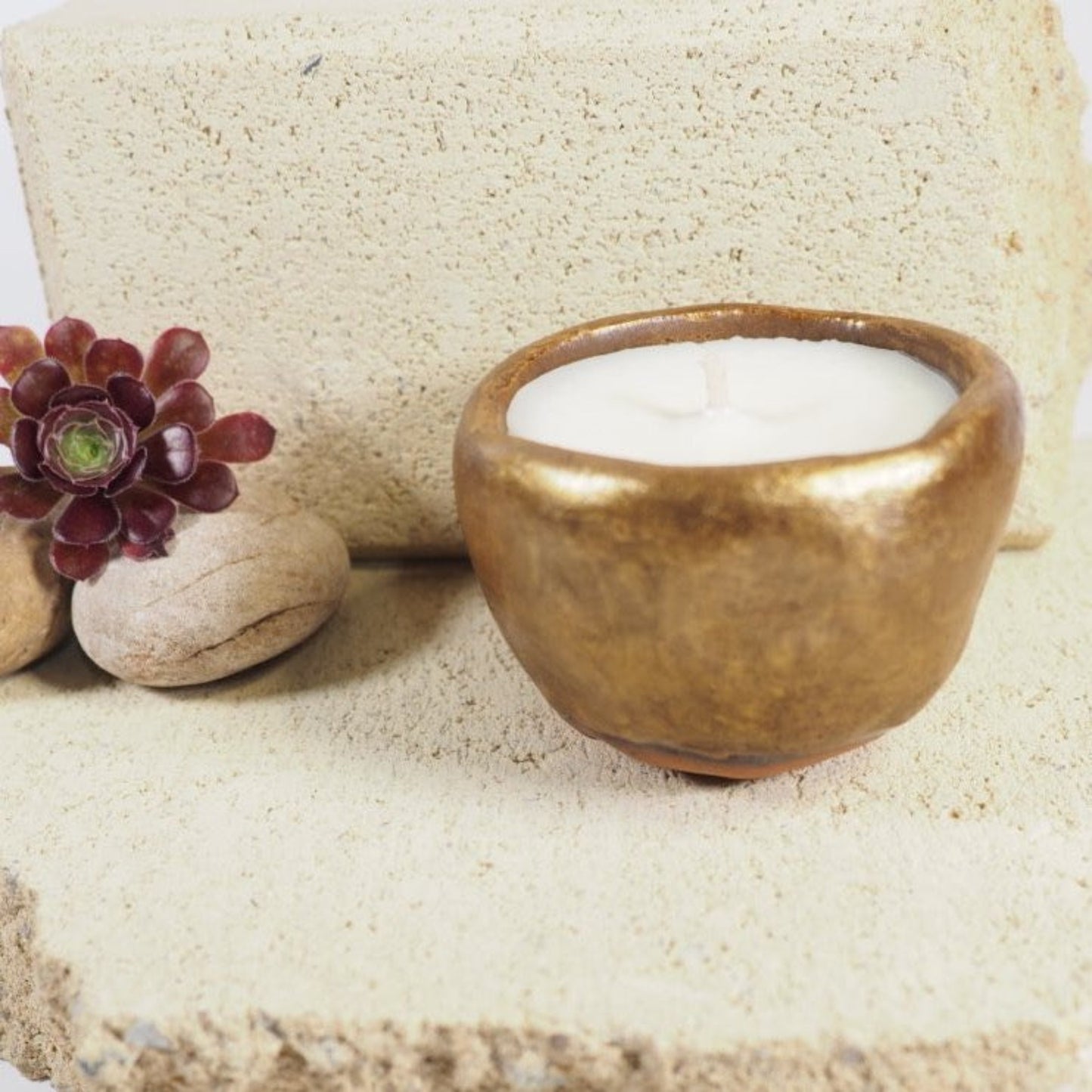 Ceramic candle pot in gold glaze filled with coconut and soy wax
