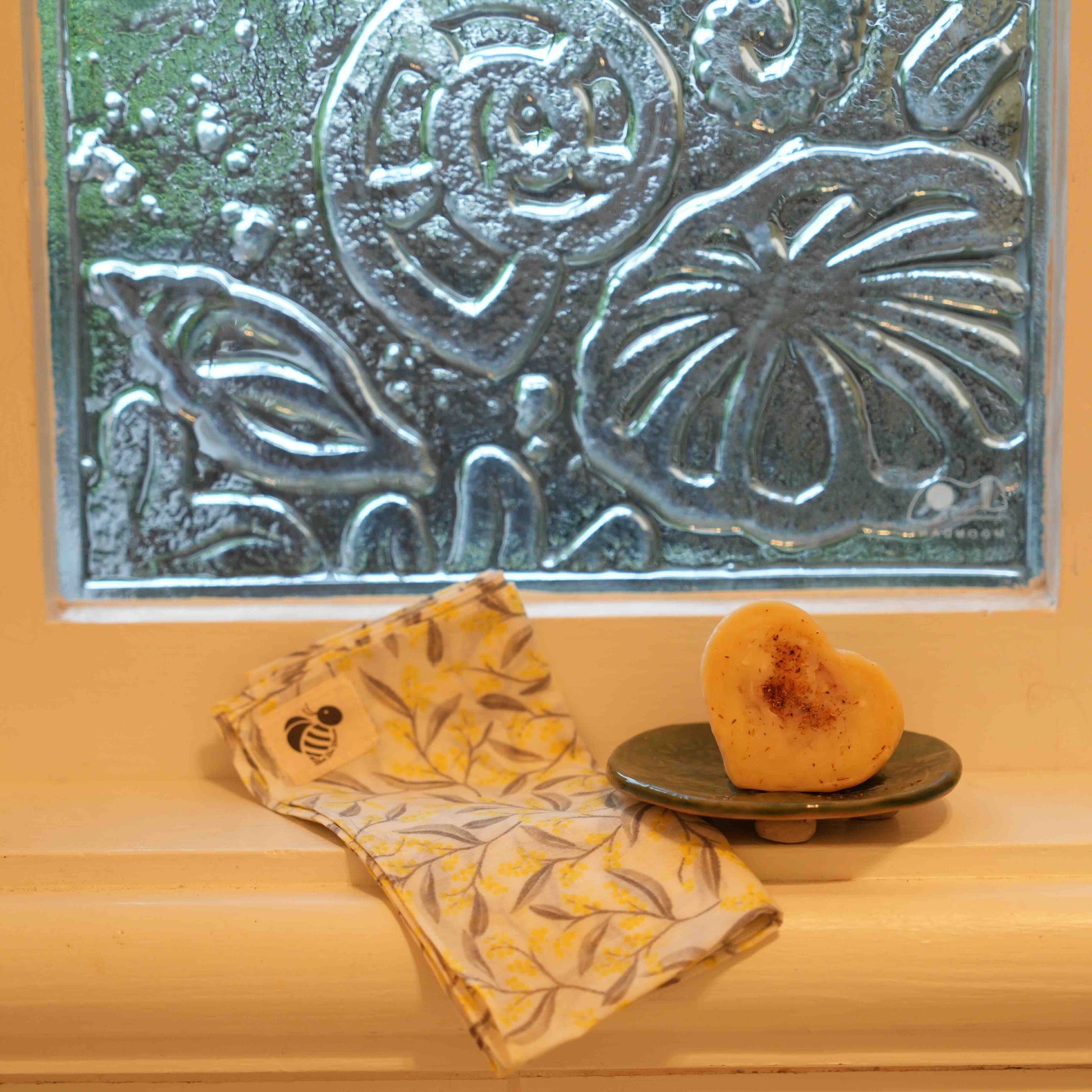 Bathroom window sill with Ceramic soap dish, WA Sandalwood Organic Cleansing Heart and facecloth