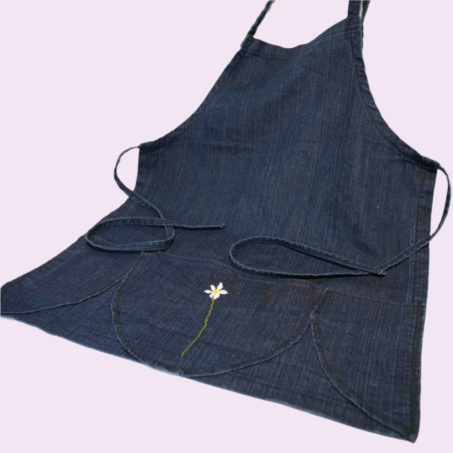 Handmade blue denim apron with a flower embroidered on pocket