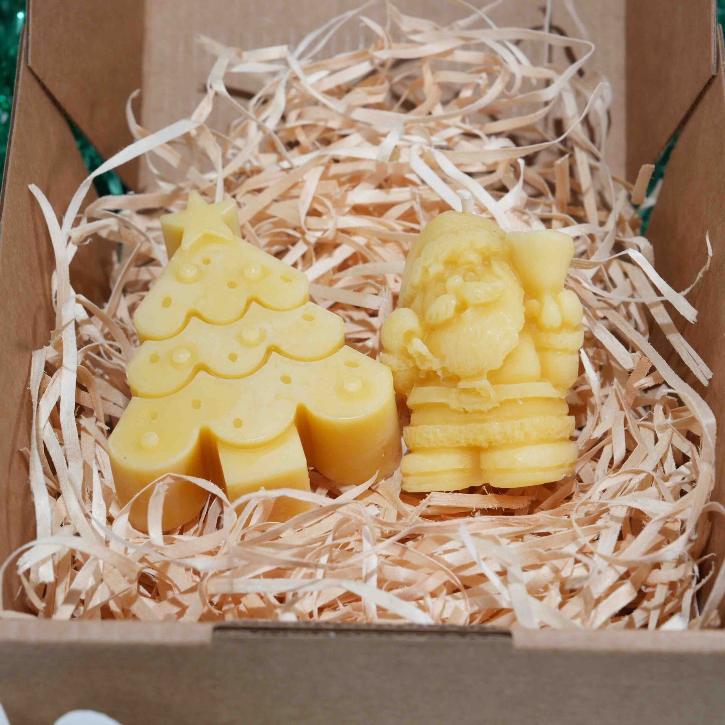 Christmas beeswax candle with one Christmas tree and one Santa in gift box