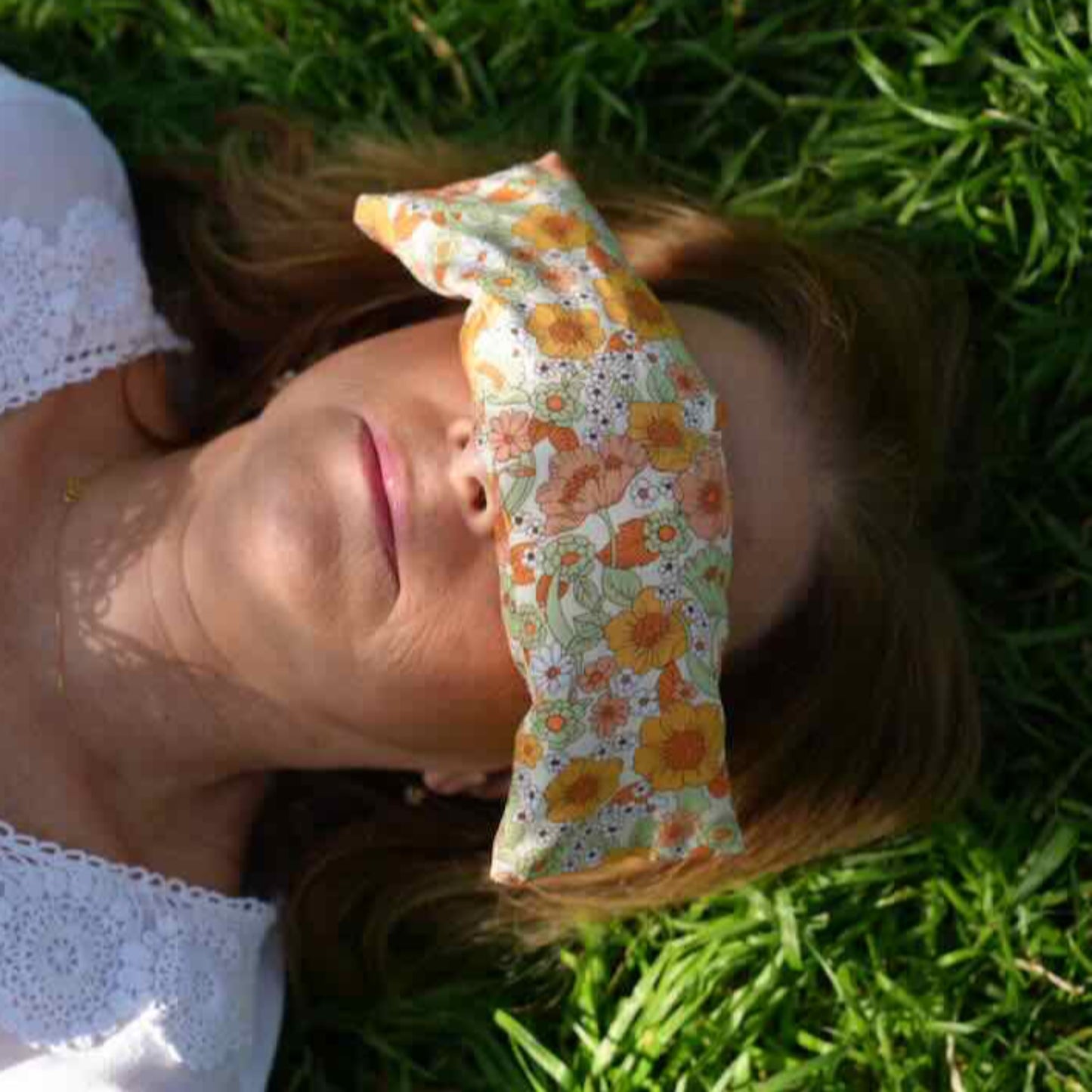 Louise with organic cotton floral print eye pillow over eyes