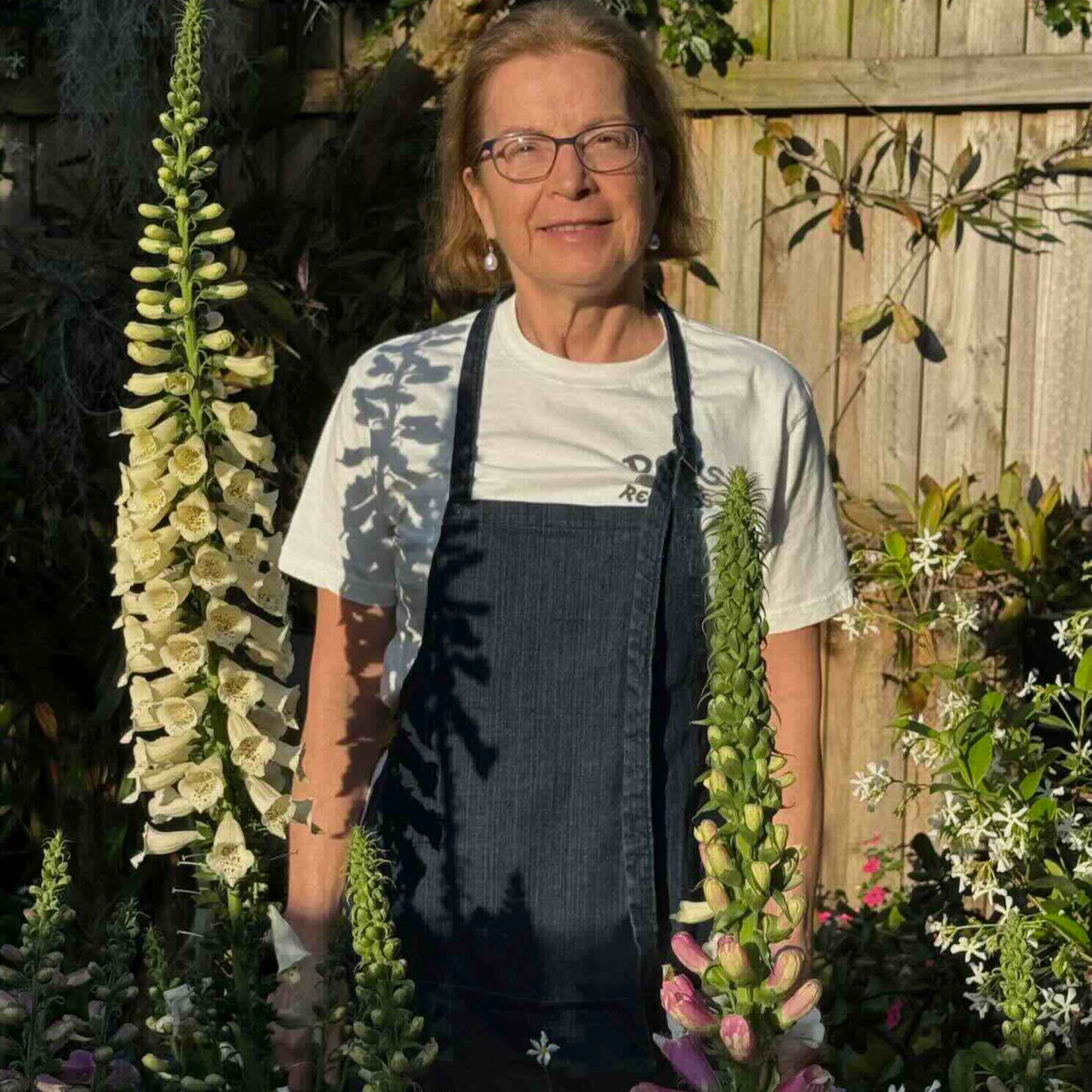 Louise wearing denim apron in her garden