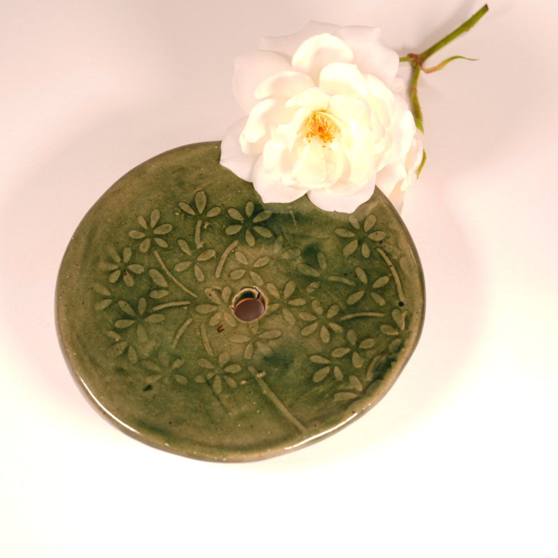 Round olive green soap dish with imprinted flower design