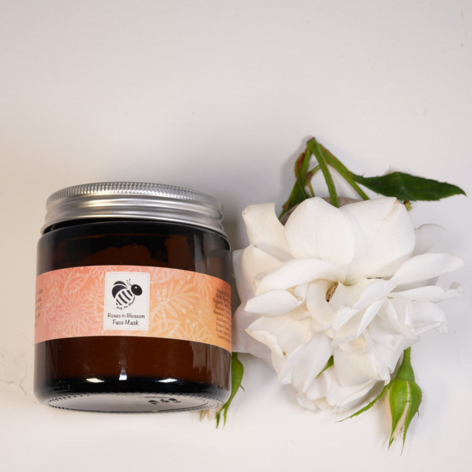Roses in blossom cream face mask in an amber glass jar with roses