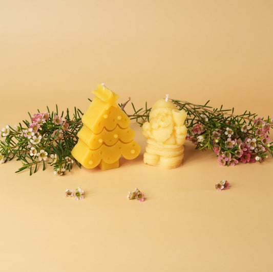 Beeswax candles in Santa and Christmas tree