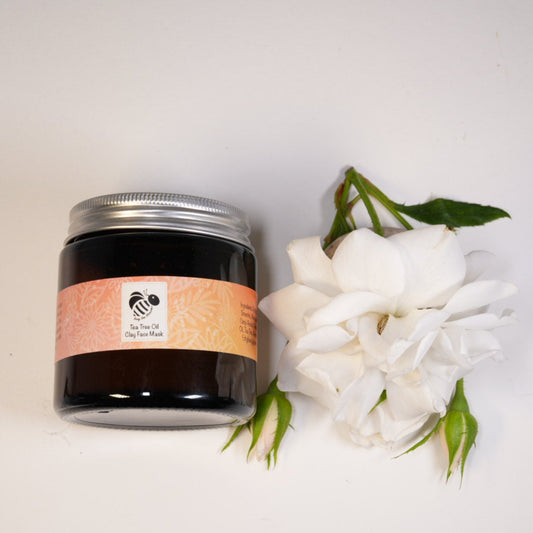 Tea tree oil clay face mask in amber glass jar with roses