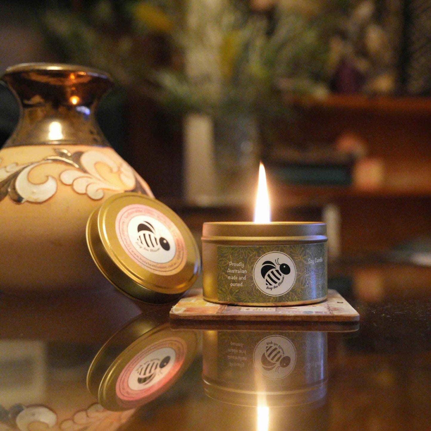 Travel tin candle scented in Bergamot and Banksia lit in my loungeroom