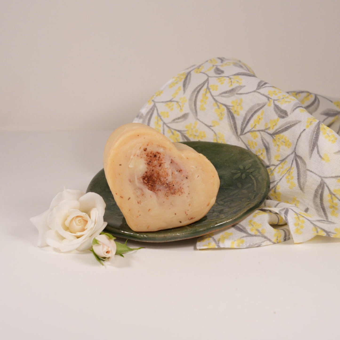 WA Sandalwood Cleansing Bar on olive round ceramic soap dish and wattle face cloth