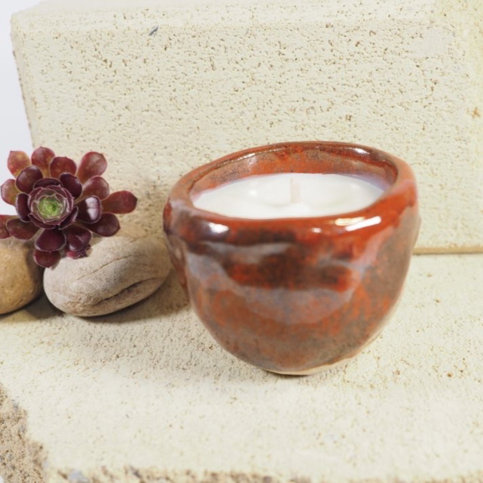 Ceramic candle pot in tomato red glaze filled with coconut and soy wax