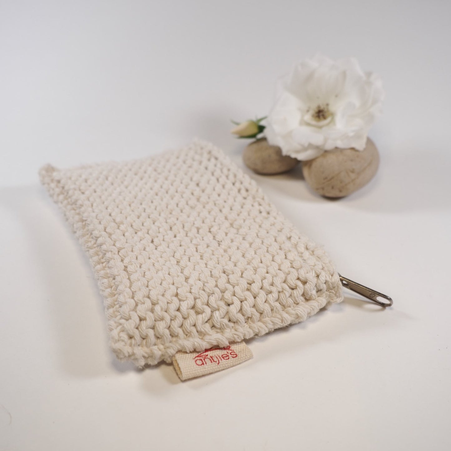 Hand knitted cotton lip balm bag with rock and rose
