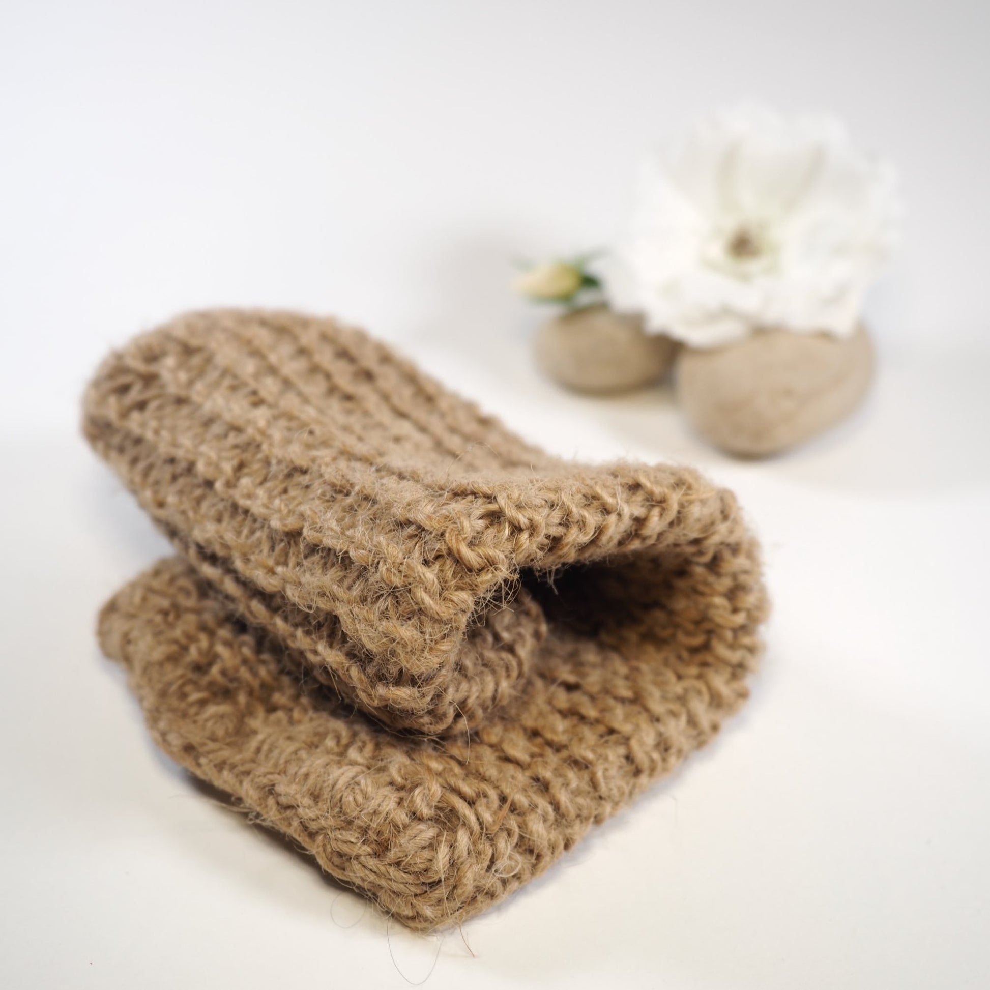 Hand crocheted jute mitt folded over with rock and rose